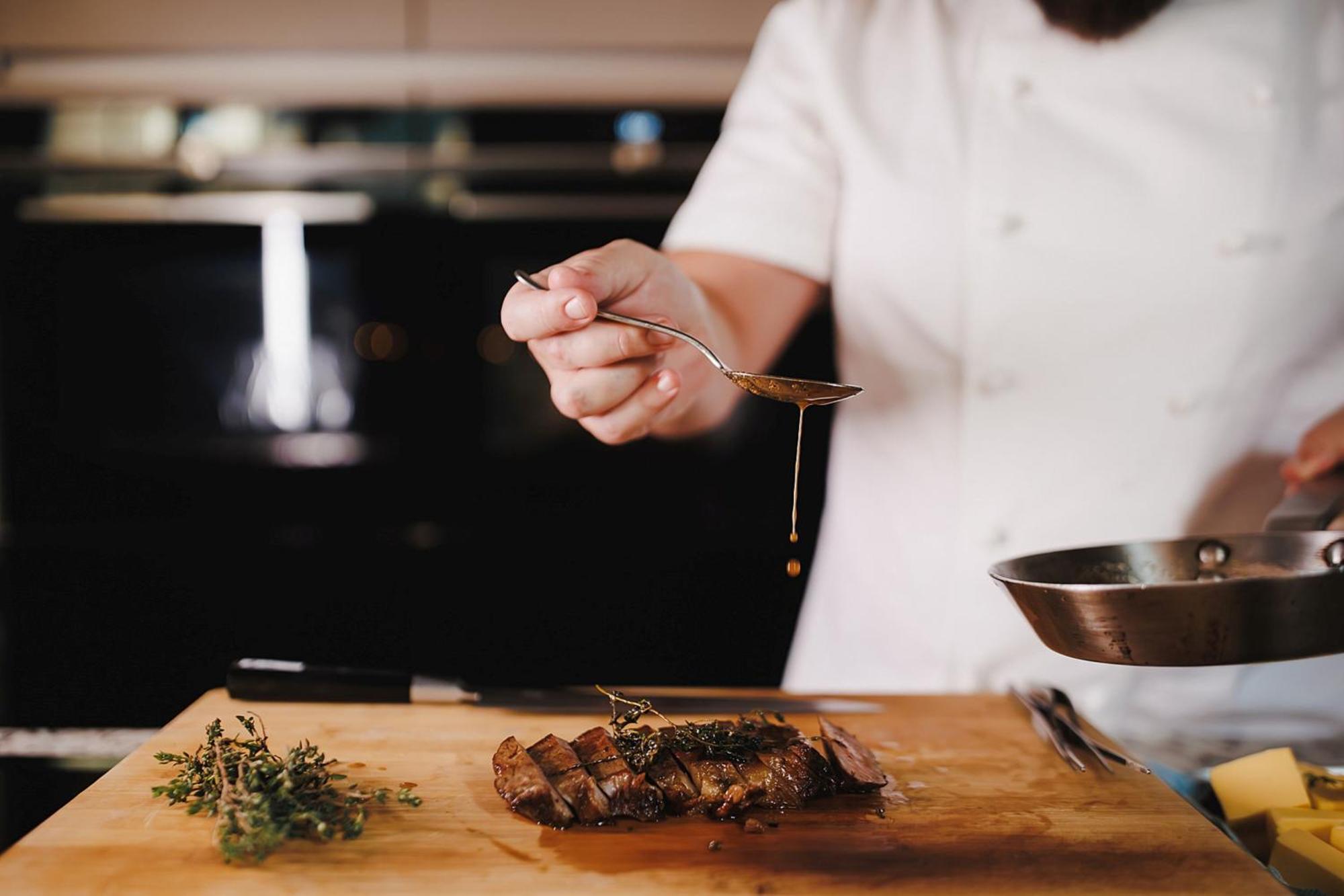 Stock Exchange Hotel, Manchester, Autograph Collection Ngoại thất bức ảnh A chef seasoning a dish
