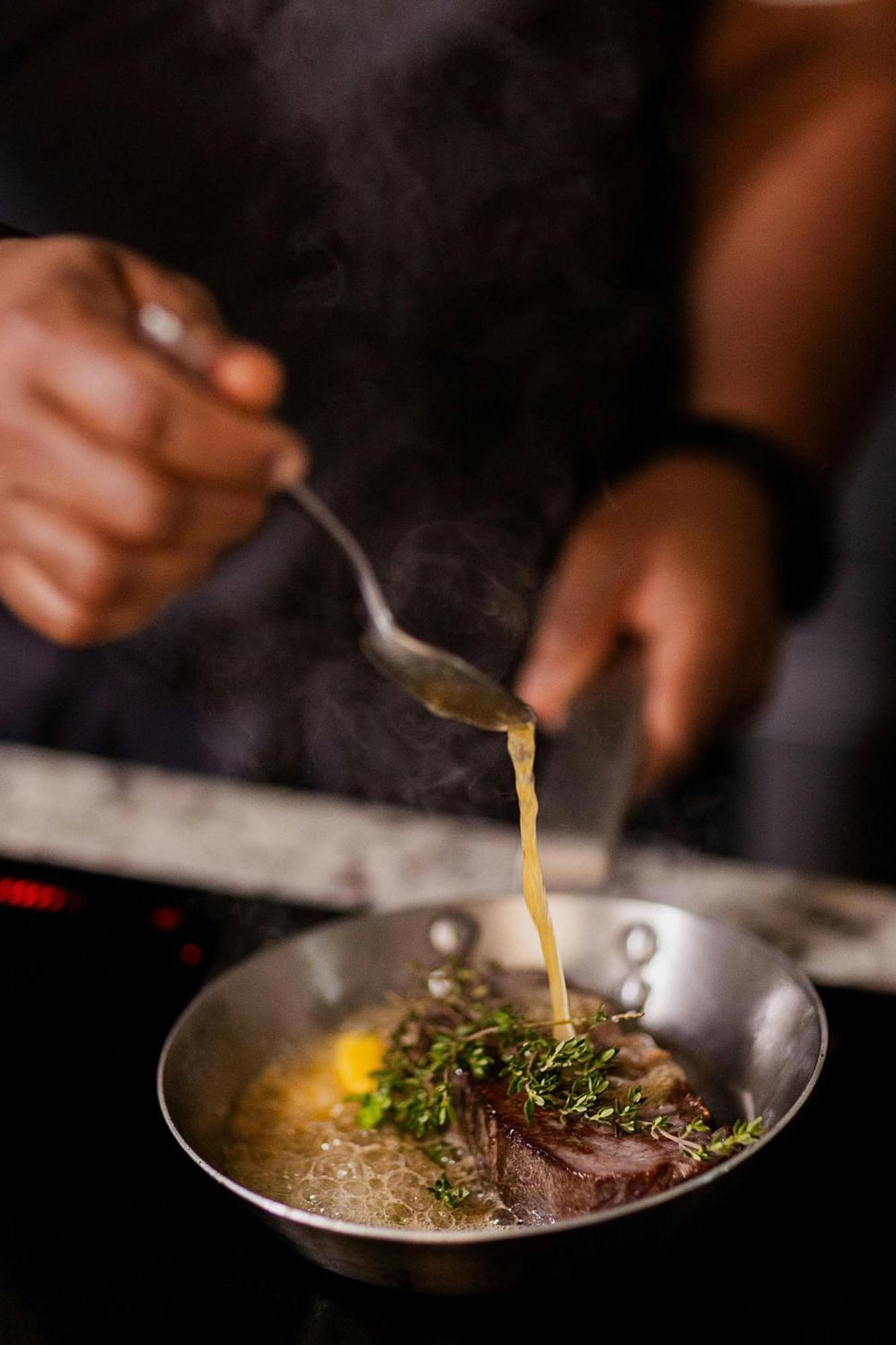 Stock Exchange Hotel, Manchester, Autograph Collection Ngoại thất bức ảnh A chef seasoning a dish